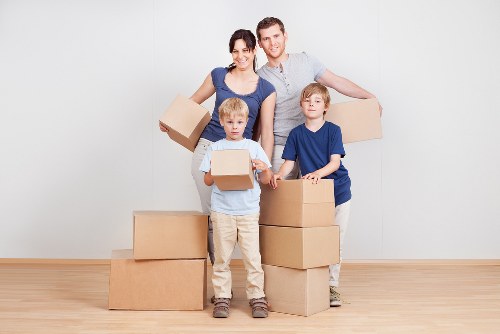 Professional moving team handling furniture on a residential street in Snaresbrook