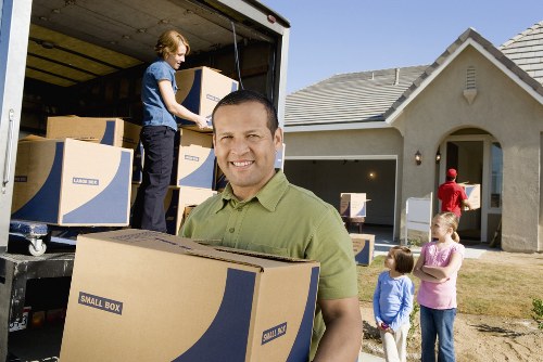 Commercial moving team handling office furniture and boxes in a local Snaresbrook property